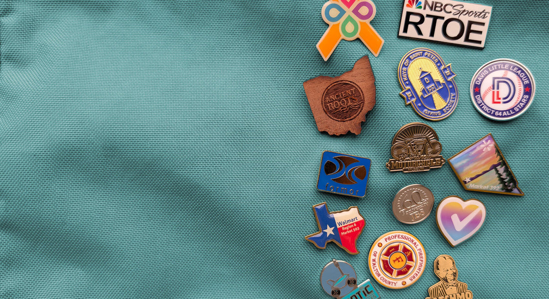 An array of custom pins, including wooden, enamel, metal, and printed pins.