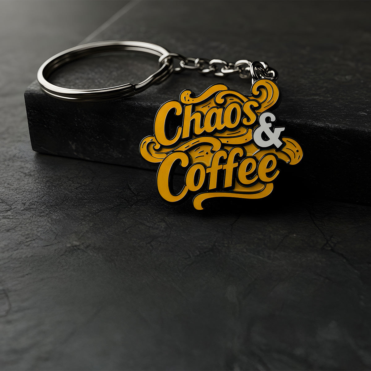 Custom metal keychain that says "Chaos & Coffee" in stylized orange letters